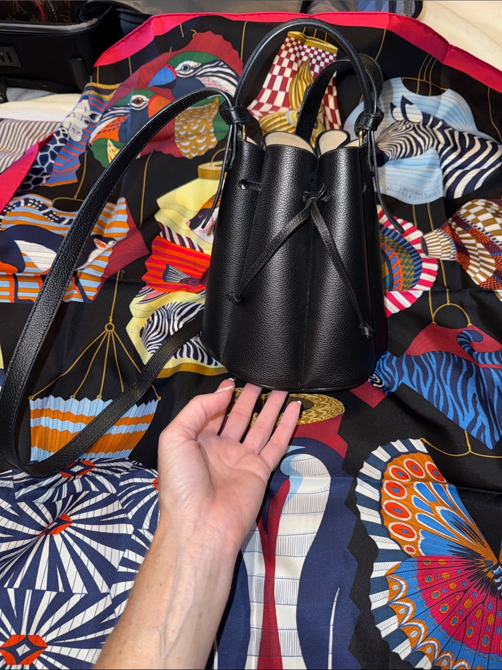 Poléne Black Leather Bucket Bag with top handle and crossbody strap